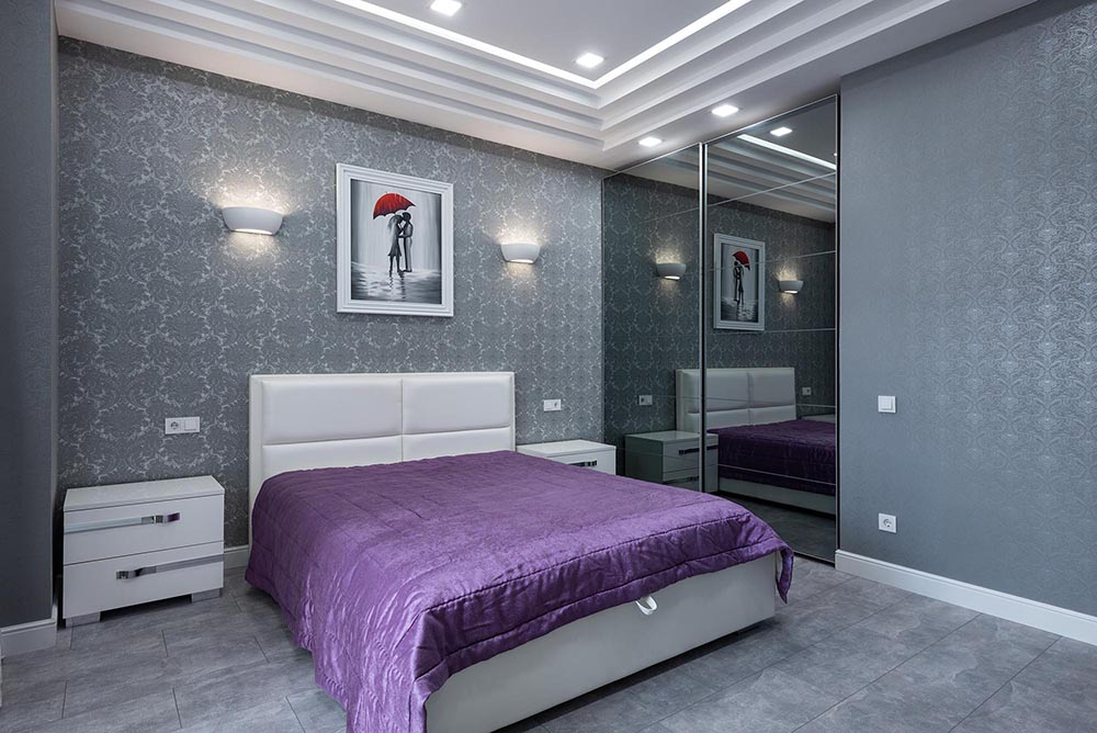 a bedroom in purple and grey